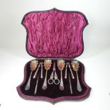 A Victorian silver plated fruit set, comprising four serving spoons,