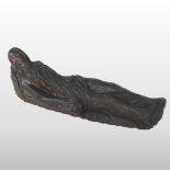 An 18th century carved of a lady, lying down holding a skull,
