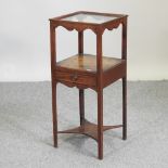 A George III mahogany two tier wash stand, containing a single drawer, on square legs,