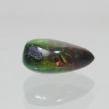 An unmounted pear shaped black opal, approx 5.