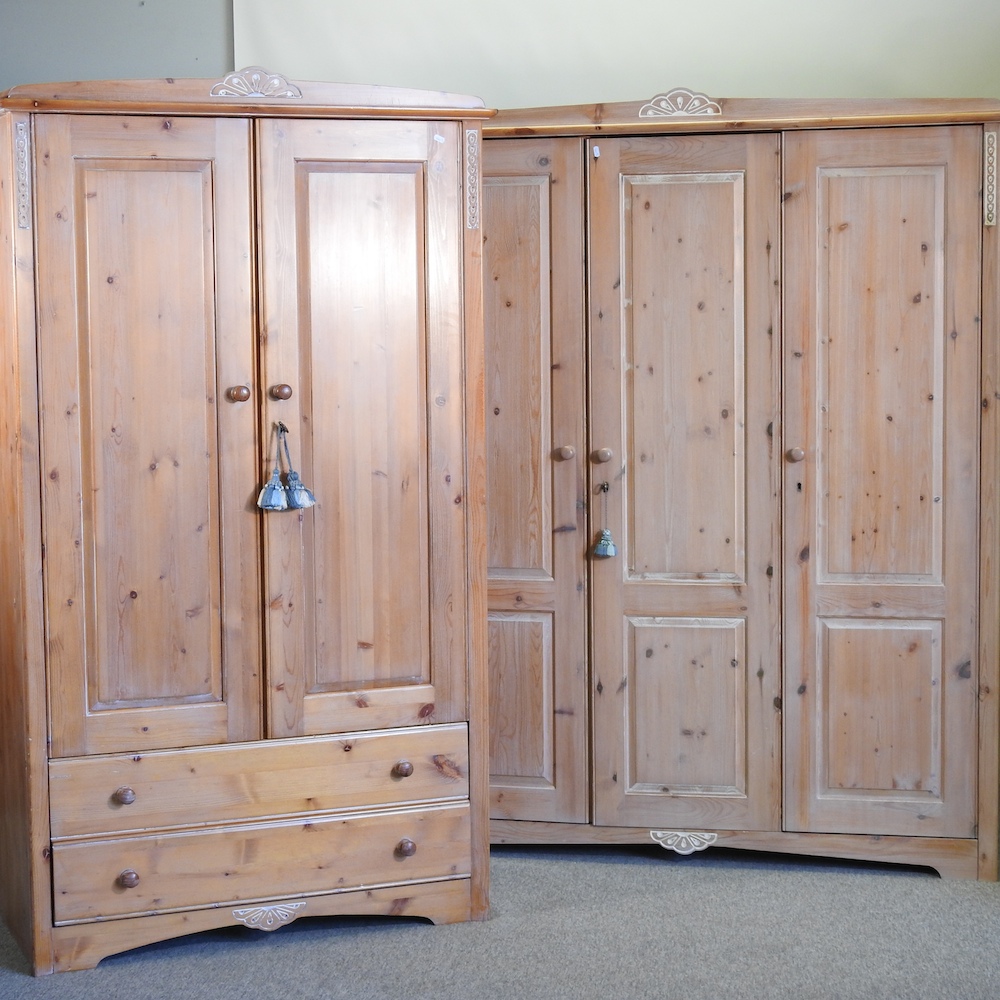 A Marks and Spencer pine triple wardrobe, 144cm, together with a matching double wardrobe,