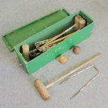 A wooden croquet set, in a green painted box,