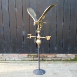A gilt painted metal weather vane, in the form of an eagle, on stand,