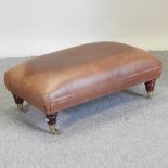 A modern brown leather upholstered footstool,