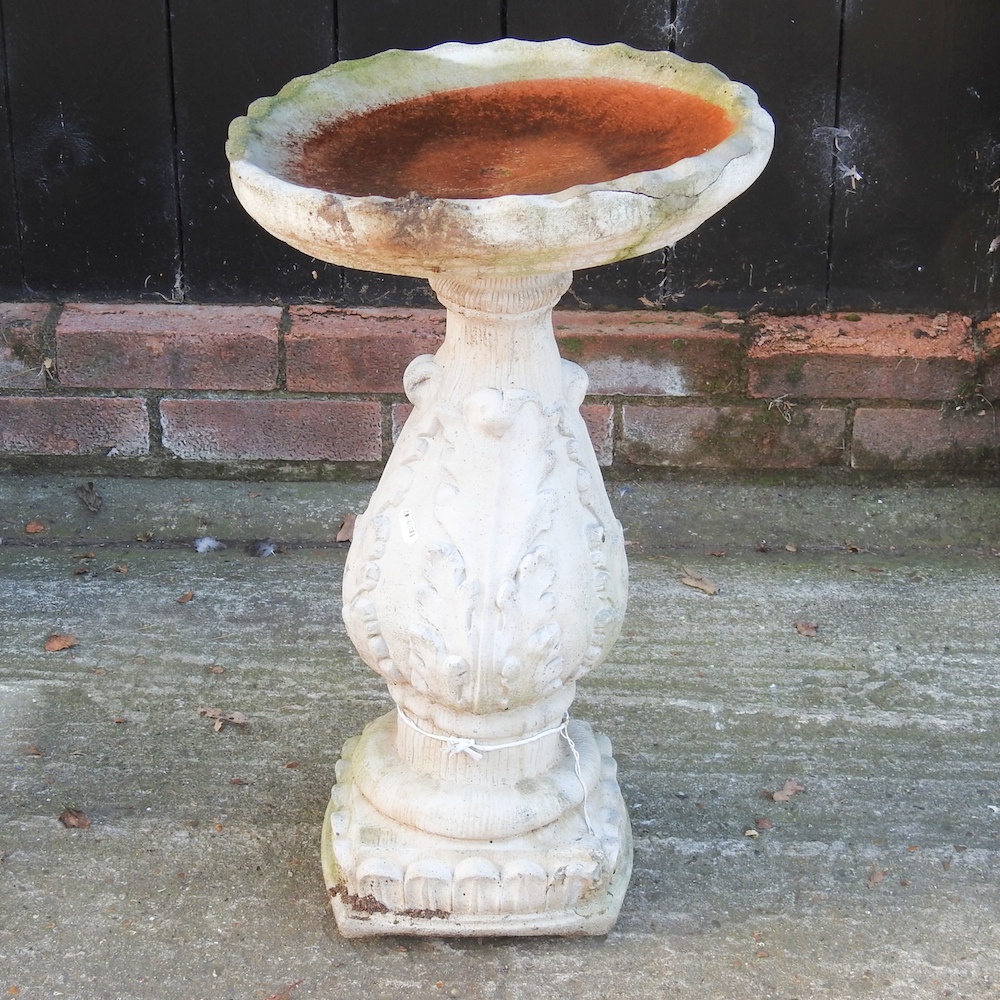 A reconstituted stone bird bath,