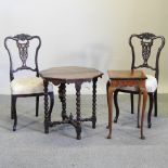 A pair of mahogany and cream upholstered chairs, together with a walnut occasional table,