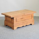 A light oak coffee table, with a lift-up lid,