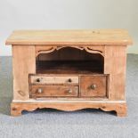 An antique pine cabinet,