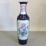 An unusually large Chinese porcelain vase, reserved with a floral panel,