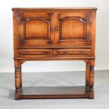 A 19th century style oak and crossbanded cabinet,