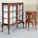 A hardwood glazed oval drinks cabinet, together with an early 20th century display cabinet,