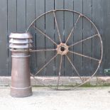 A cast iron cart wheel, together with a stoneware chimney pot,