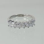 An 18 carat white gold and diamond half hoop eternity ring