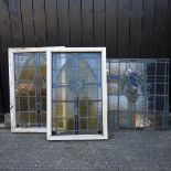 A stained glass window mounted in a frame, 114 x 74cm, together with another similar,