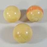 Three early 20th century ivory billiards balls,