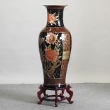A large oriental vase, on a hardwood stand,