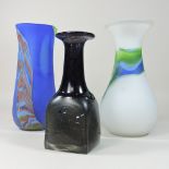 A glass vase, together with two coloured glass vases,