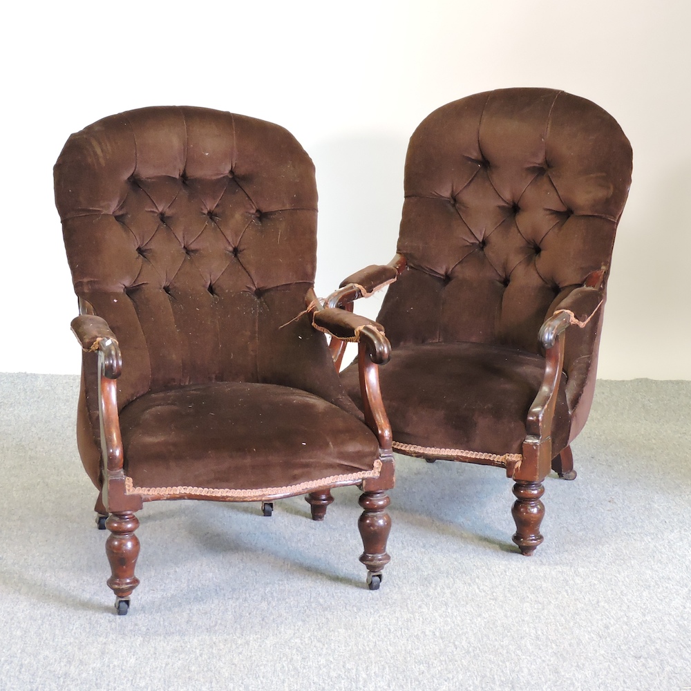A pair of Victorian brown upholstered button back armchairs