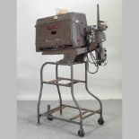 A 1950's Bell & Howell cinema projector, on stand,