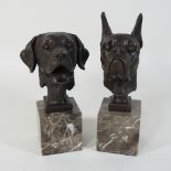 A bronze head of a dog, on a marble base, together with another,