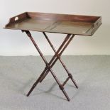 A reproduction butlers tray, on a folding stand,