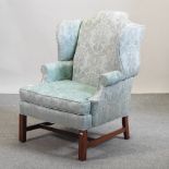 A Georgian style turquoise upholstered wingback armchair,