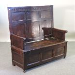 A 19th century oak settle, with a lift up seat,