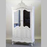 A Laura Ashley white painted armoire, with mirrored doors,