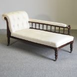 A Victorian cream upholstered chaise longue,