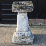 A stone pedestal bird bath,