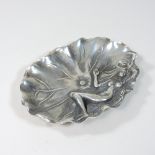 An Art Nouveau style metal dish, decorated with a figure of a lady,