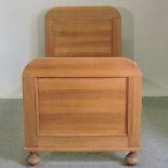 A continental pine single bedstead,