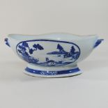 A 19th century Chinese porcelain blue and white porcelain dish, painted with a landscape,