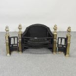 A cast iron and brass fire grate,