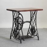 An early 20th century sewing table, on a cast iron base,