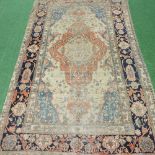 An early 20th century Persian carpet, with a central ivory medallion, within multiple borders,