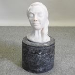 A life size composition sculpture of a head of a lady, mounted on a plinth,