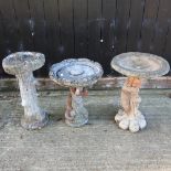 A reconstituted stone bird bath,