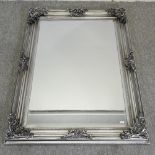 A silver painted framed wall mirror,