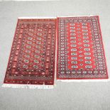 A Bokhara rug, with two rows of cream medallions, on a red ground, 174 x 97cm,
