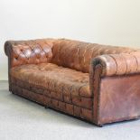 A tan leather button upholstered chesterfield sofa,