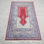 An Eastern prayer rug, with central medallion, within multiple borders,