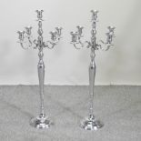 A pair of plated candelabra,