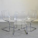 A set of three 1970's moulded plastic and tubular chrome cantilever dining chairs