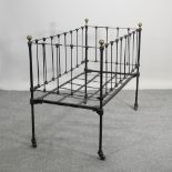 A Victorian black painted cot,