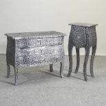 A metallic chest of drawers, together with a matching bedside cabinet,