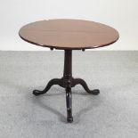 A 19th century mahogany occasional table, with a bird cage action, on a tripod base,