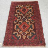A Turkish rug, with two diamond pattern, on a red ground,