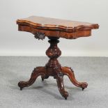 A Victorian burr walnut serpentine card table, on a quadruped splayed base,