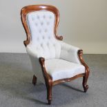 A Victorian carved walnut and cream upholstered armchair,